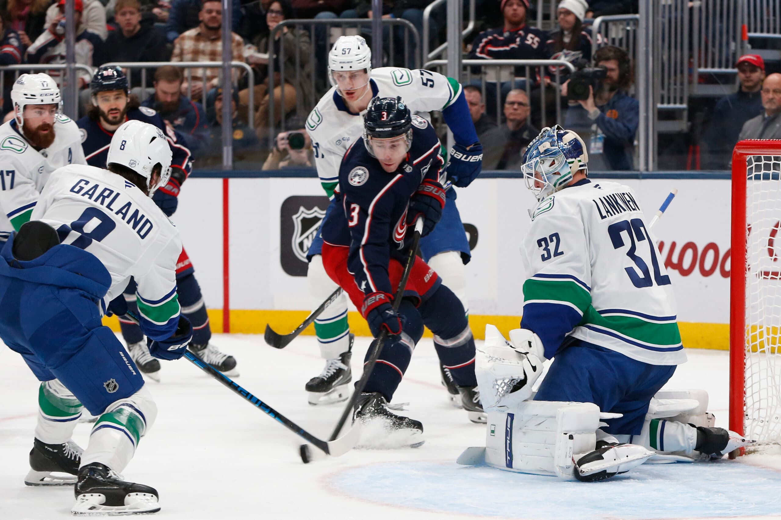 Jan 15, 2026; Columbus, Ohio, USA; Columbus Blue Jackets center Charlie Coyle (3) shoots a rebound of a Vancouver Canucks goalie Kevin Lankinen (32) save on goall during the second period at Nationwide Arena. Mandatory Credit: Russell LaBounty-Imagn Images