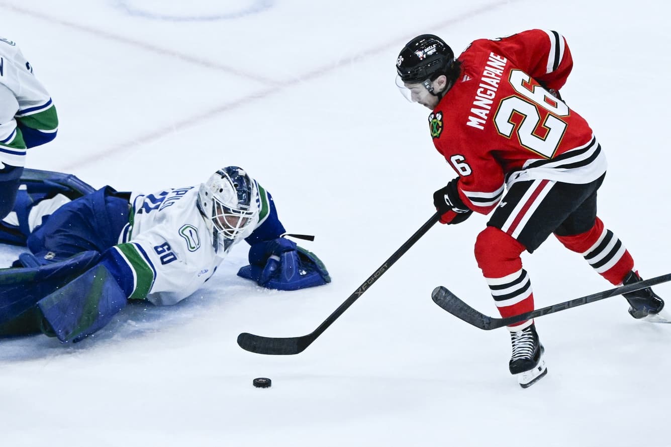 Chicago Blackhawks left wing Andrew Mangiapane (26) shoots against Vancouver Canucks goaltender Nikita Tolopilo (60) during the third period at United Center.