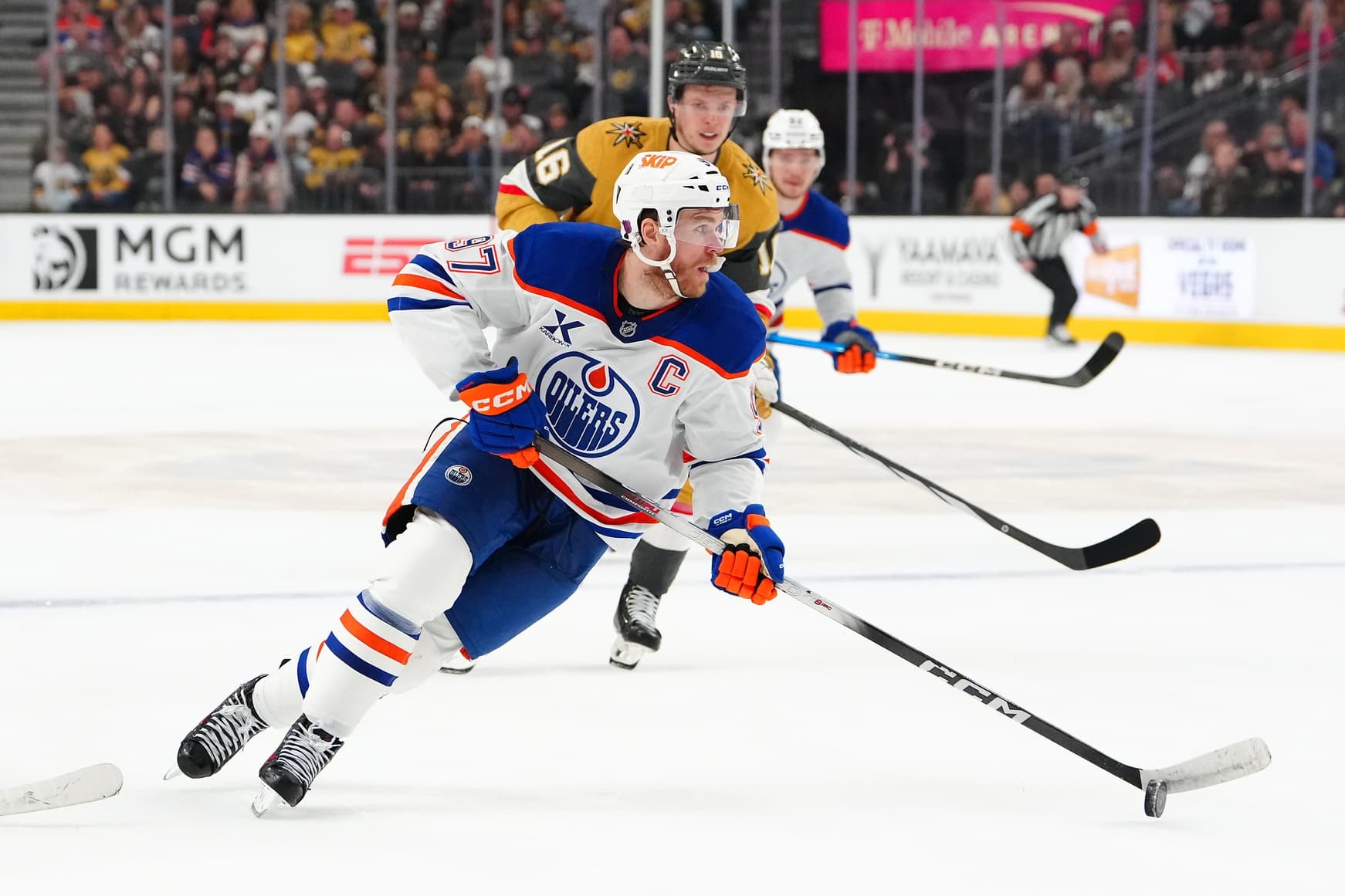 Edmonton Oilers center Connor McDavid (97) controls the puck ahead of Vegas Golden Knights right wing Pavel Dorofeyev (16) during the first period at T-Mobile Arena.